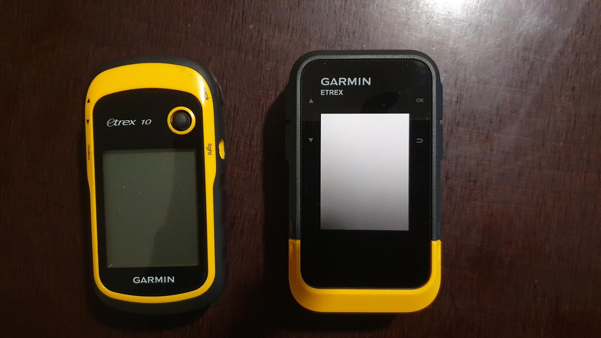 Garmin eTrex 10 and Garmin SE side by side on a brown wood
table